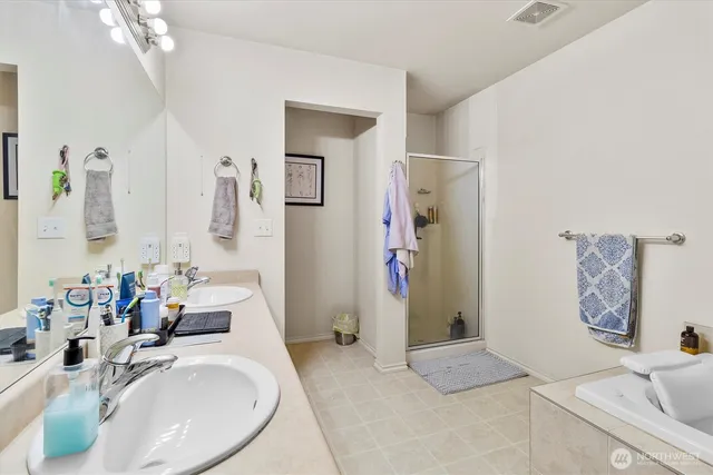 a bathroom with a tub sink and mirror
