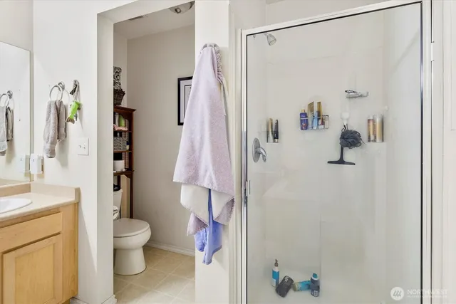 a bathroom with a shower toilet and sink