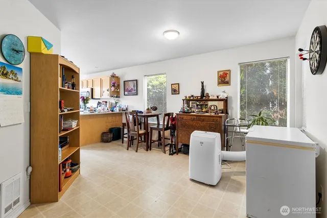 a dining room with furniture and a floor to ceiling window