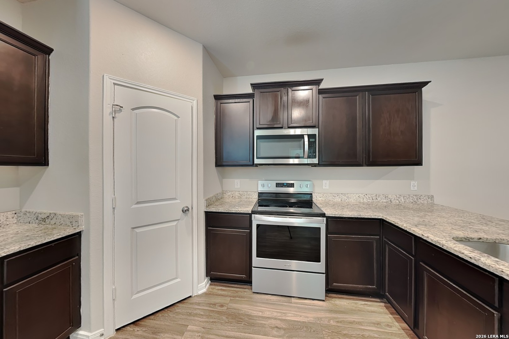 3022 Citron Garden Converse, TX 78109 - Photo 4 of 21 a kitchen with stainless steel appliances granite countertop a sink stove and refrigerator