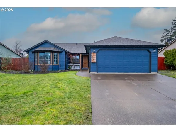 a view of a house with a yard and garage