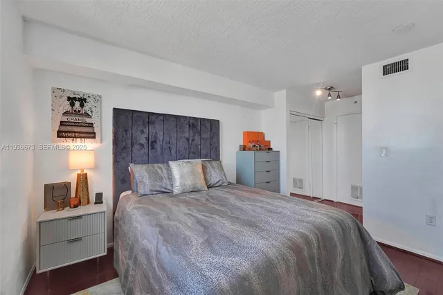 a bedroom with a bed and a closet