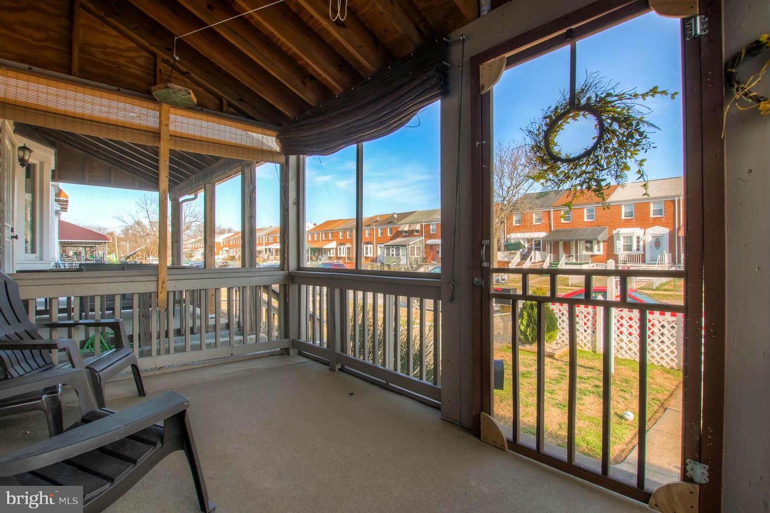 1950 Quentin Road Baltimore, MD 21222 - Photo 5 of 27 a porch with wooden floor in front of a house