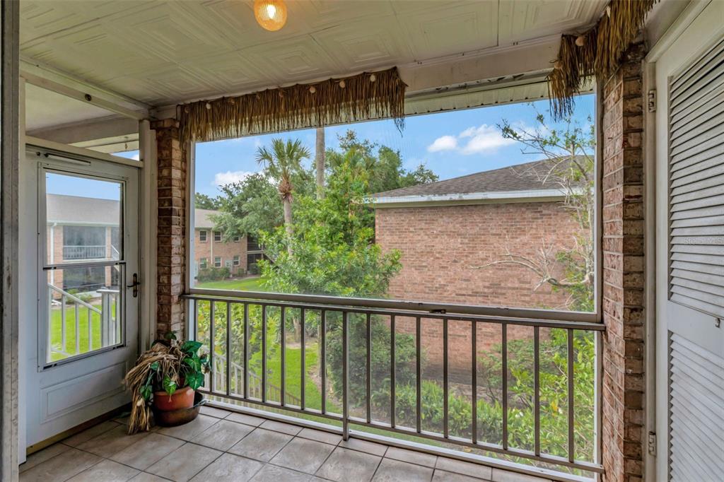 4216 Lake Underhill Road, Unit 6A28 Orlando, FL 32803 - Photo 18 of 18 a view of a glass door with a balcony from a window