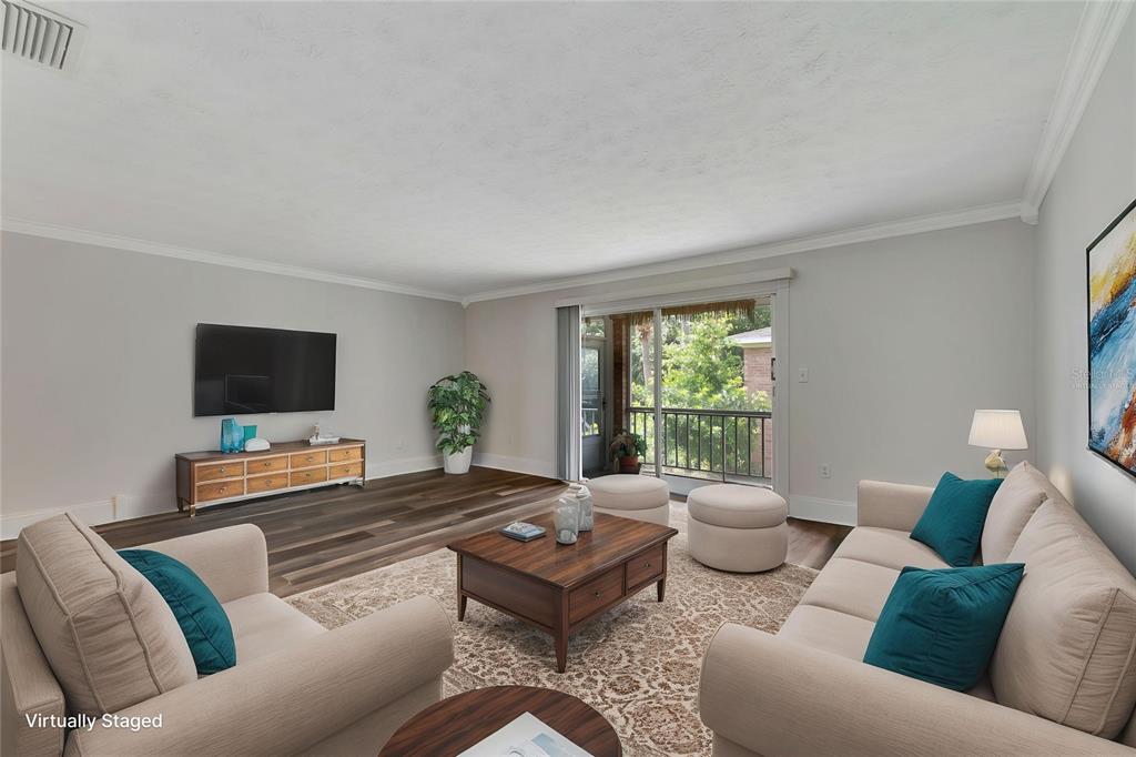 4216 Lake Underhill Road, Unit 6A28 Orlando, FL 32803 - Photo 4 of 18 a living room with furniture and a flat screen tv