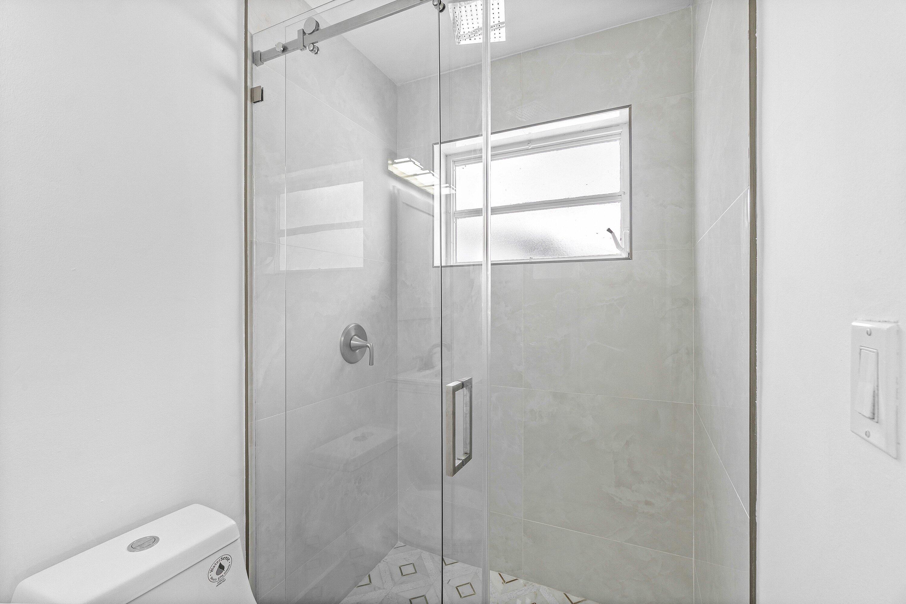 1531 Northwest 4th Street Boca Raton, FL 33486 - Photo 28 of 34 a bathroom with a glass shower door