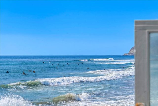 a bedroom with a bed and white cabinets
