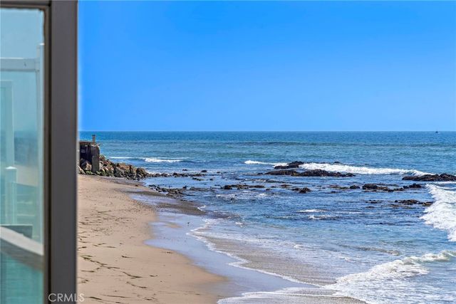 a bedroom with two beds and a chair
