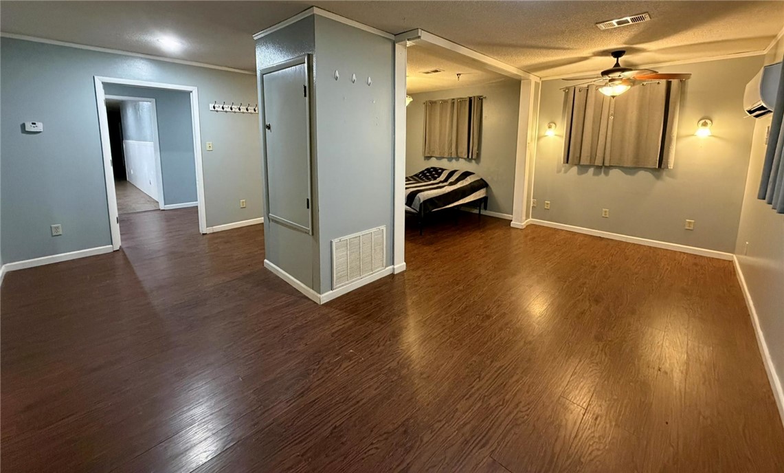 5108 Ridge Road Alma, AR 72921 - Photo 24 of 33 Spacious interior room featuring wood-finish flooring, light gray walls, white baseboards, and a ceiling fan with integrated lighting