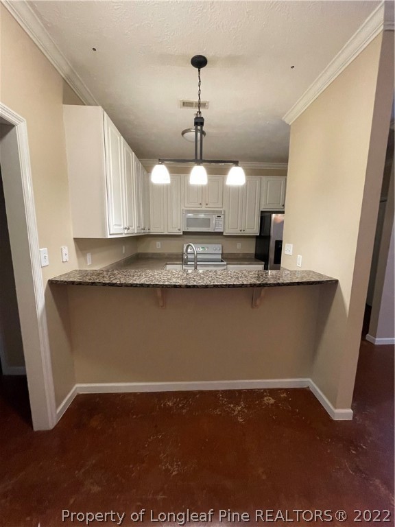 517 Lionshead Road, Unit 4 Fayetteville, NC 28311 - Photo 6 of 19 a kitchen with kitchen island granite countertop a sink a center island stainless steel appliances and a window