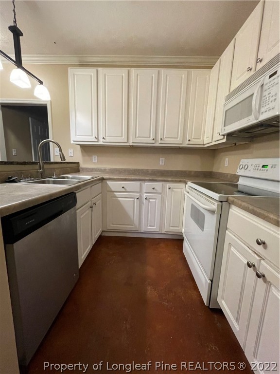 517 Lionshead Road, Unit 4 Fayetteville, NC 28311 - Photo 7 of 19 a kitchen with white cabinets sink and stove