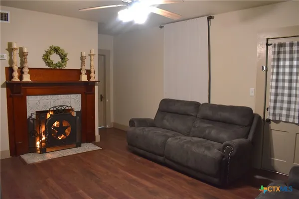 a living room with furniture and a fireplace