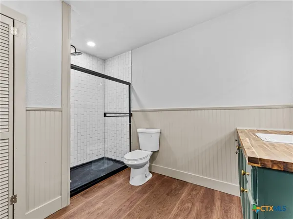 a bathroom with a toilet and a shower