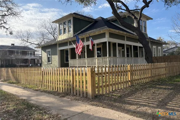 a front view of a house with a fence