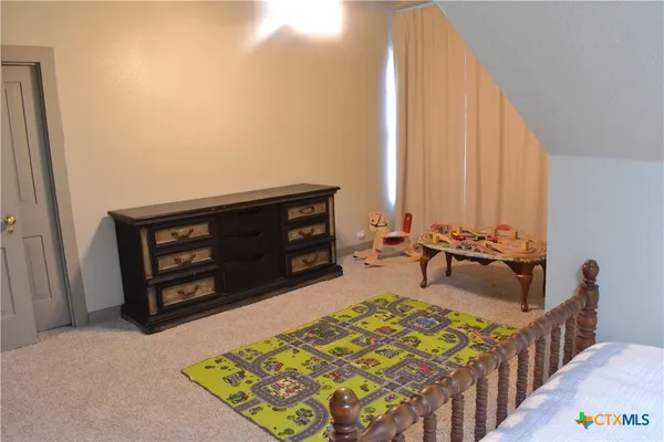 a bedroom with a bed and a ceiling fan