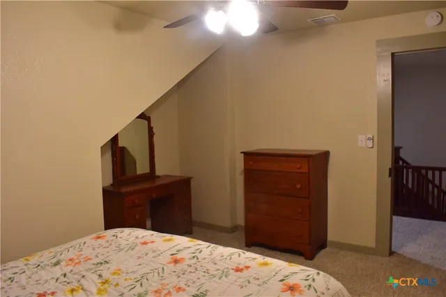 a bedroom with a bed and a couch