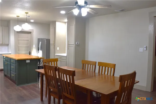 a view of a a dining room with furniture and a chandelier