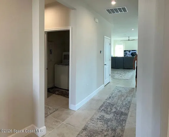 a view of a hallway to a bedroom and a room