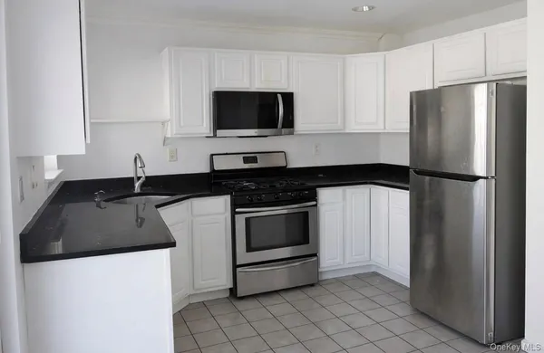 a kitchen with a sink and a refrigerator