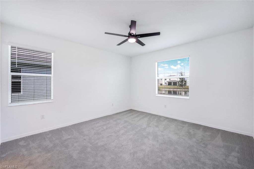 2434 Orchard Street Naples, FL 34120 - Photo 12 of 29 an empty room with a window and ceiling fan