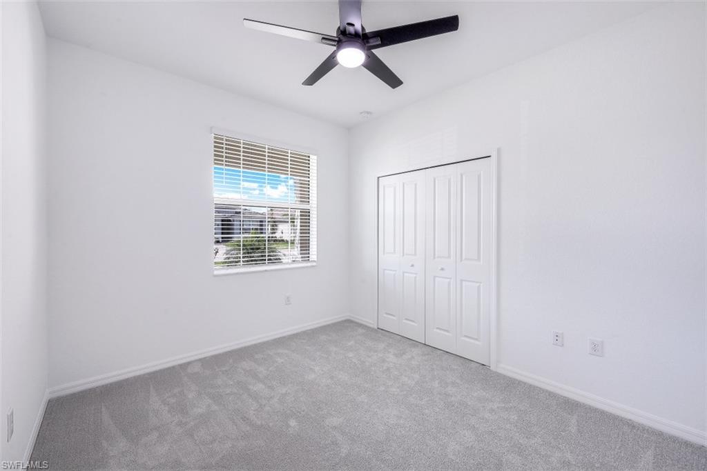 2434 Orchard Street Naples, FL 34120 - Photo 15 of 29 an empty room with windows and fan