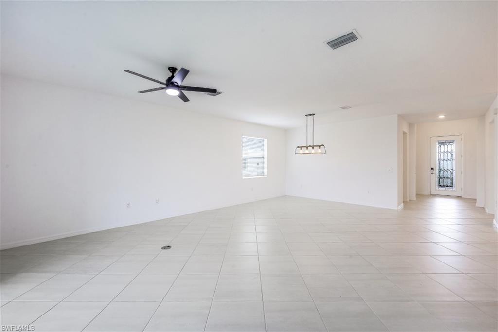 2434 Orchard Street Naples, FL 34120 - Photo 4 of 29 an empty room with a empty space and a ceiling fan