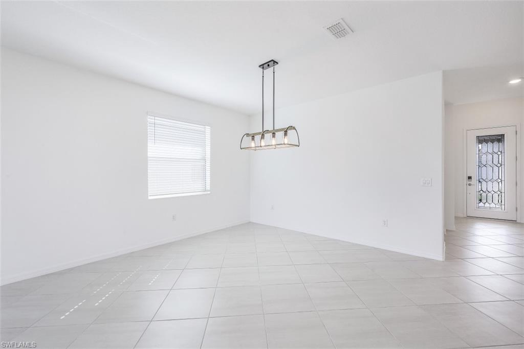 2434 Orchard Street Naples, FL 34120 - Photo 10 of 29 an empty room with windows and fan