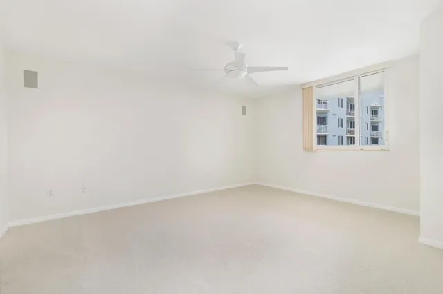 an empty room with a empty space and windows