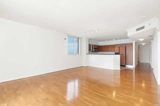 a view of a kitchen with a sink and a refrigerator