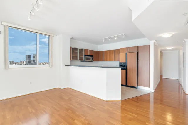 a view of a kitchen with wooden floor and a kitchen
