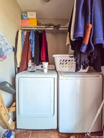 a view of walk in closet with clothes