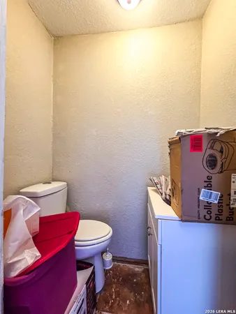 a bathroom with a toilet and a mirror