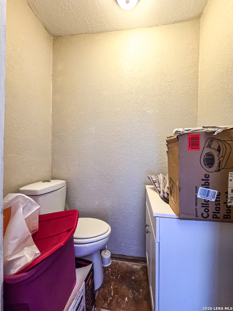 584 Chula Vista Road Eagle Pass, TX 78852 - Photo 12 of 17 a bathroom with a toilet and a mirror