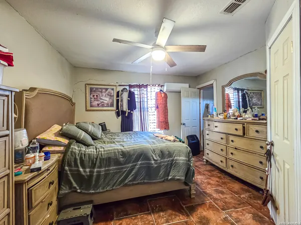 a bedroom with bed and a chandelier
