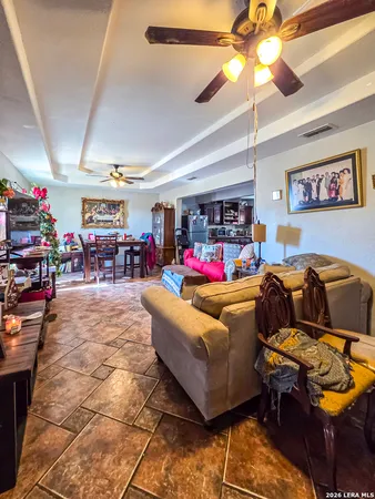 a living room with lots of furniture and a chandelier