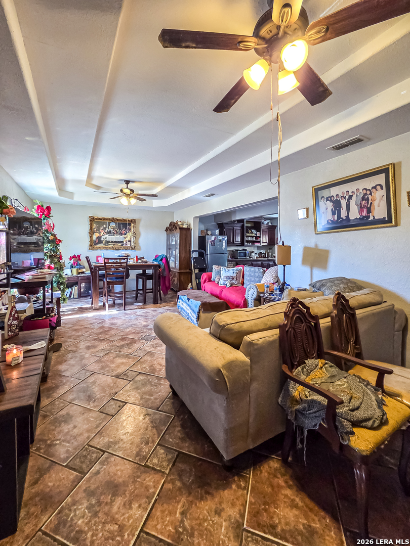 584 Chula Vista Road Eagle Pass, TX 78852 - Photo 5 of 17 a living room with lots of furniture and a chandelier