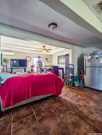 a bedroom with furniture and a large window