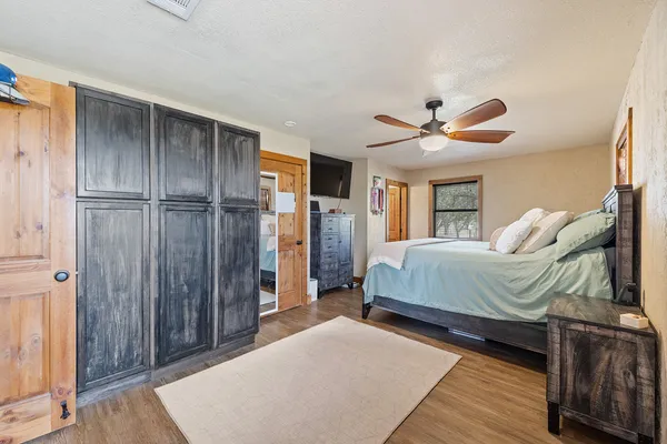 a bedroom with a bed and a ceiling fan