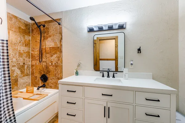 a bathroom with a sink a vanity and a mirror