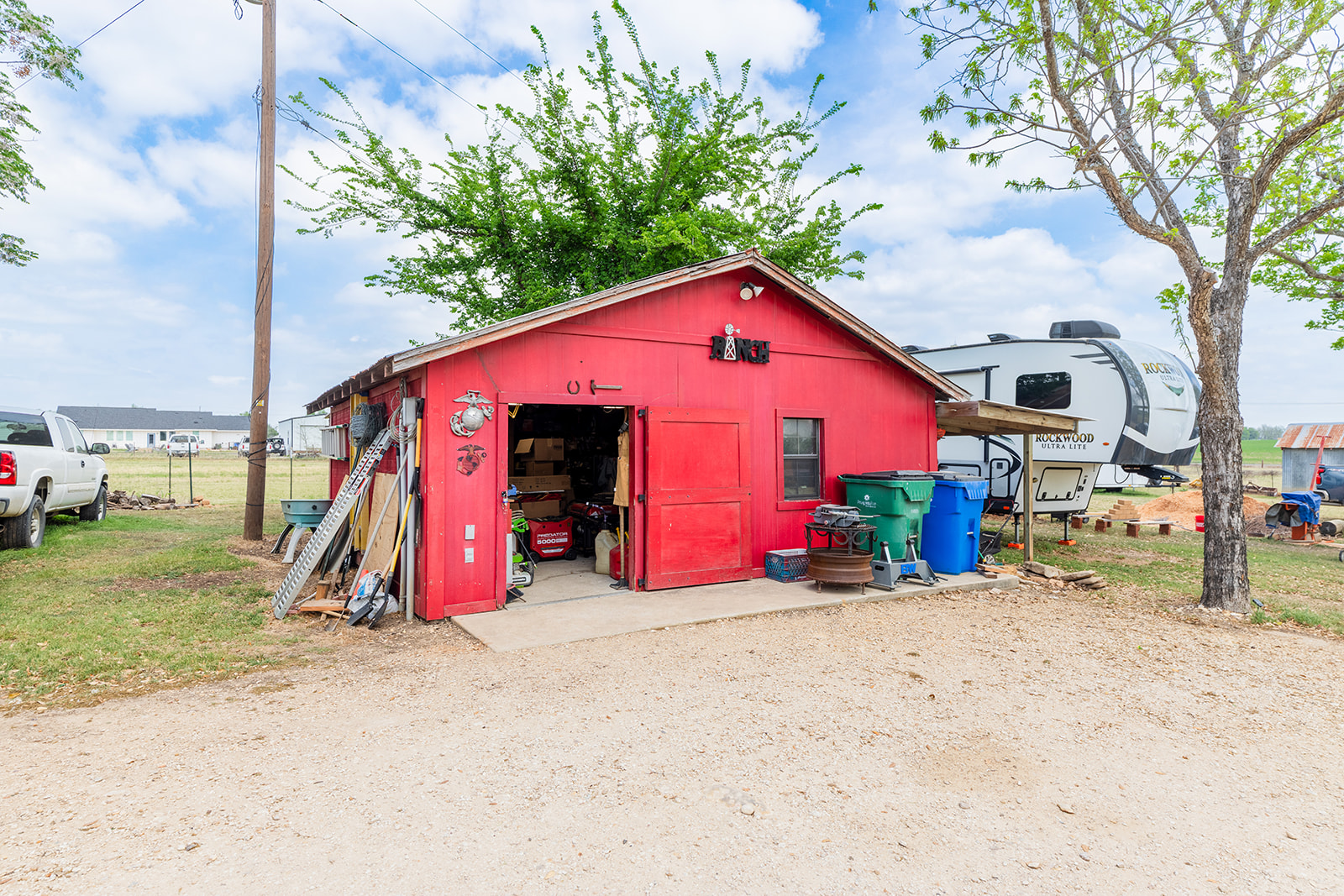 1001 Gravel Pit Road Taylor, TX 76574 - Photo 25 of 40 a view of backyard with wooden fence and a large tree