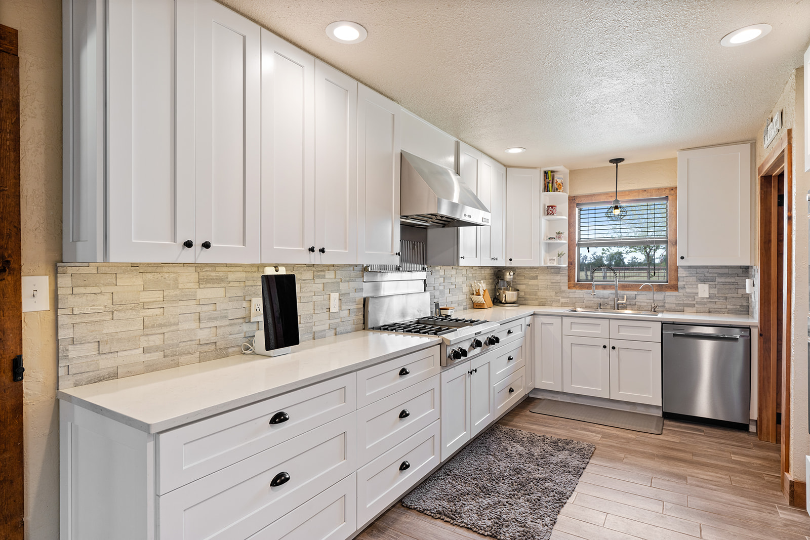 1001 Gravel Pit Road Taylor, TX 76574 - Photo 7 of 40 a kitchen with granite countertop white cabinets white stainless steel appliances with a sink and dishwasher