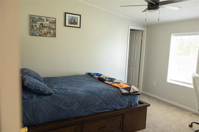 a bedroom with a bed and a wall painting