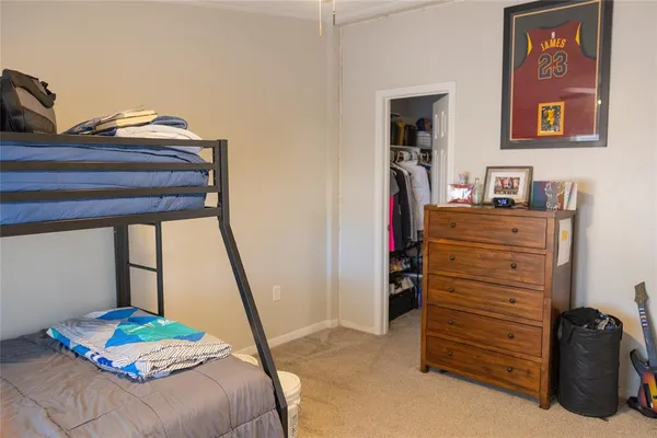 a bedroom with a bed and a book shelf