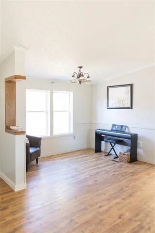 a view of a room with wooden floor and white walls