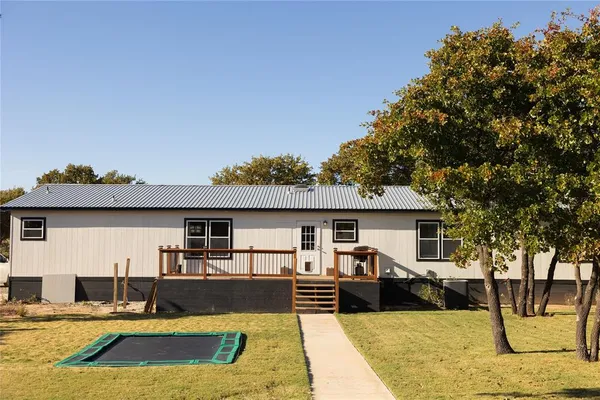 a view of a house with swimming pool and sitting area