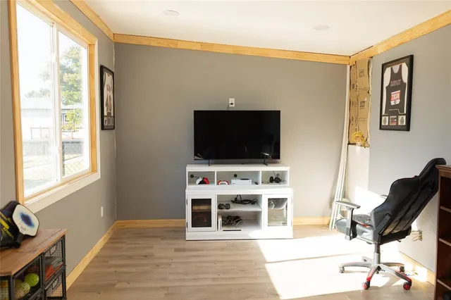 a front view of a house with a yard covered in snow