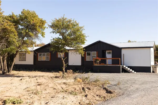 a view of a house with a yard covered in snow