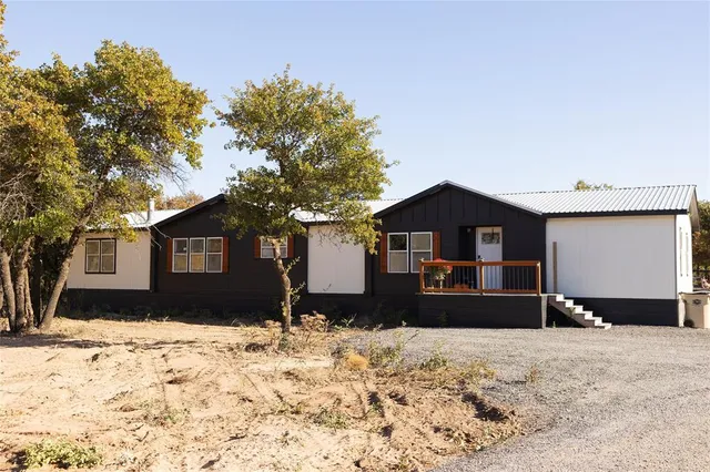 a view of a house with a yard covered in snow