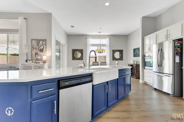 a kitchen with stainless steel appliances a sink stove and refrigerator