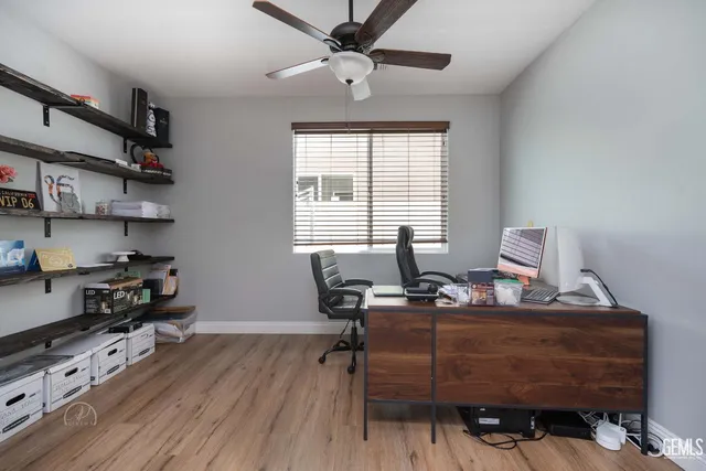a view of a workspace with furniture and a window
